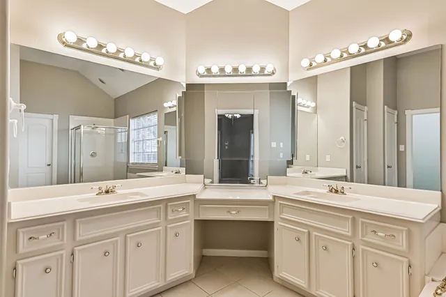 a bathroom with a sink double vanity and a mirror