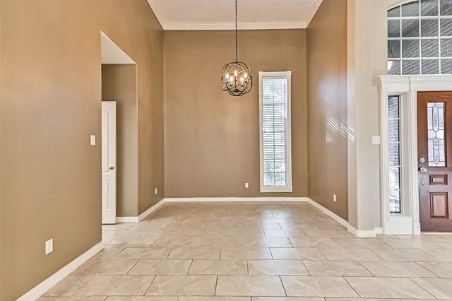 an empty room with windows and entrance