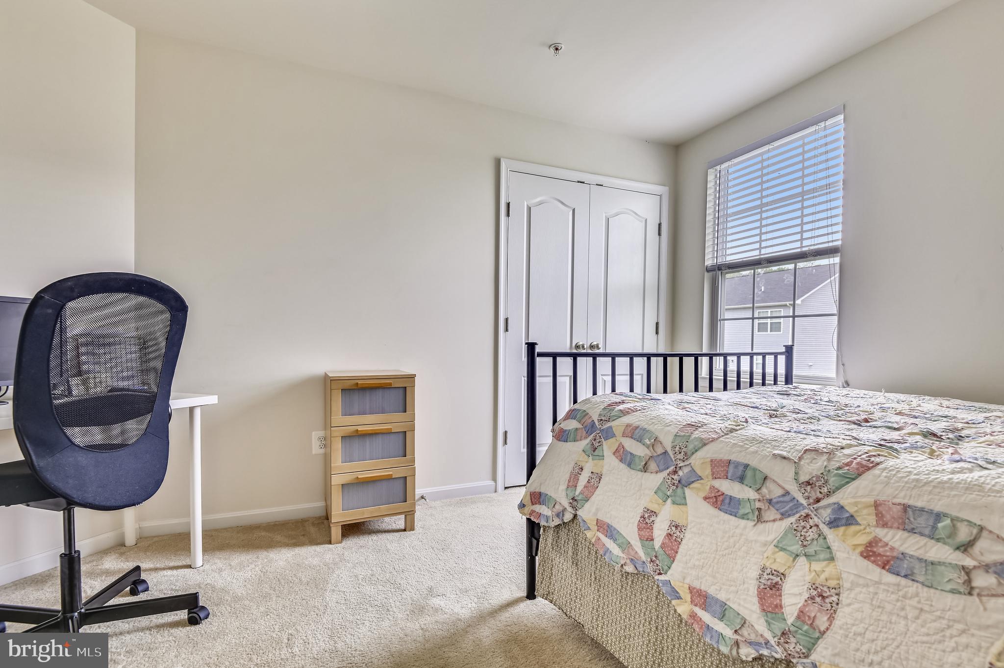735 Daft Road Baltimore, MD 21220 - Photo 23 of 32 a bedroom with a bed a lamp and a window