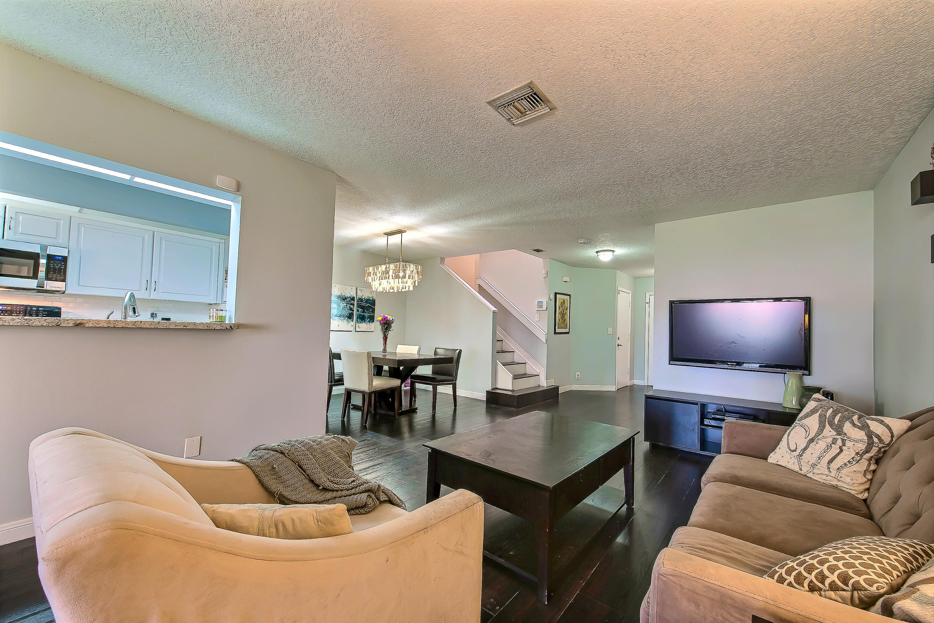 5116 Pointe Emerald Lane, Unit 5116 Boca Raton, FL 33486 - Photo 8 of 23 a living room with furniture and a flat screen tv