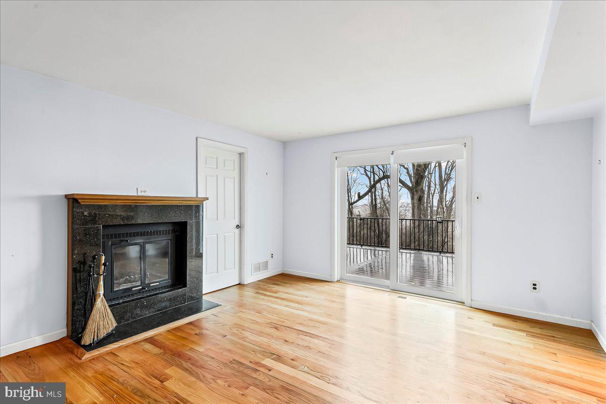 720 Brainerd Road Exton, PA 19341 - Photo 18 of 62 a view of an empty room with wooden floor and a fireplace