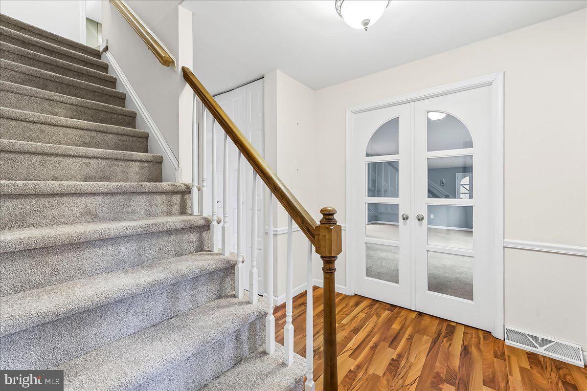 720 Brainerd Road Exton, PA 19341 - Photo 6 of 62 a view of staircase with wooden floor and a potted plant