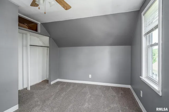 an empty room with windows and entrance