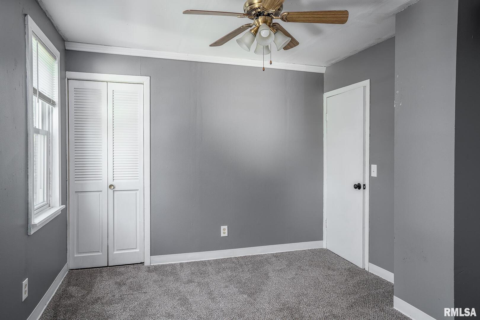 516 North Williams Street Reynolds, IL 61279 - Photo 16 of 17 an empty room with a window and a fan