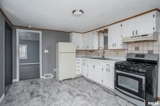 a kitchen with a stove and a refrigerator