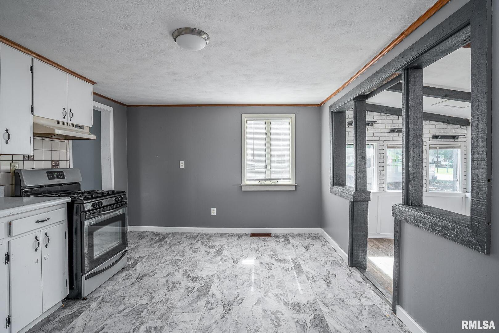 516 North Williams Street Reynolds, IL 61279 - Photo 6 of 17 a open kitchen with granite countertop a stove top oven sink and cabinets