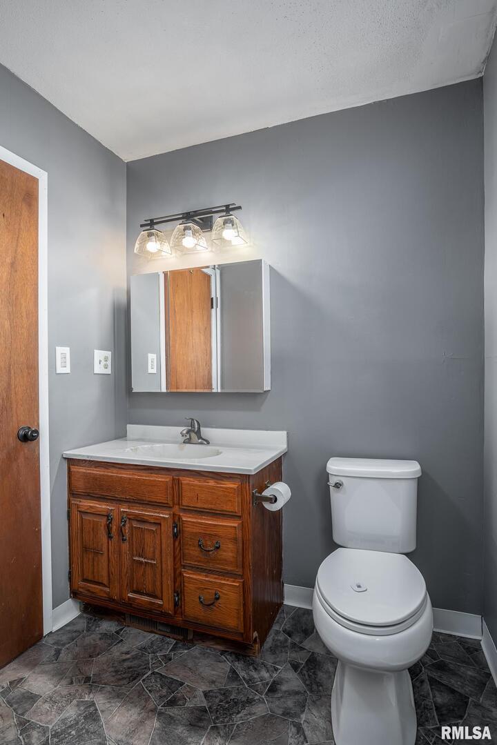 516 North Williams Street Reynolds, IL 61279 - Photo 9 of 17 a bathroom with a toilet sink and mirror