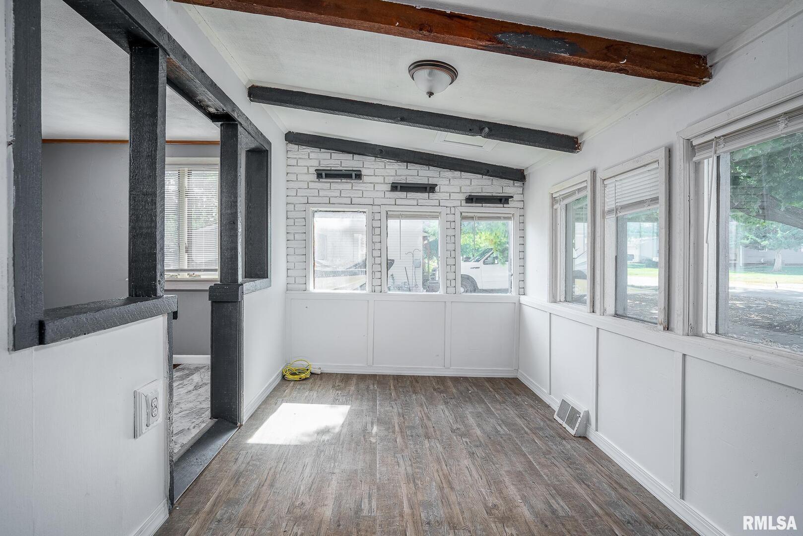 516 North Williams Street Reynolds, IL 61279 - Photo 10 of 17 a view of an empty room with wooden floor and a window
