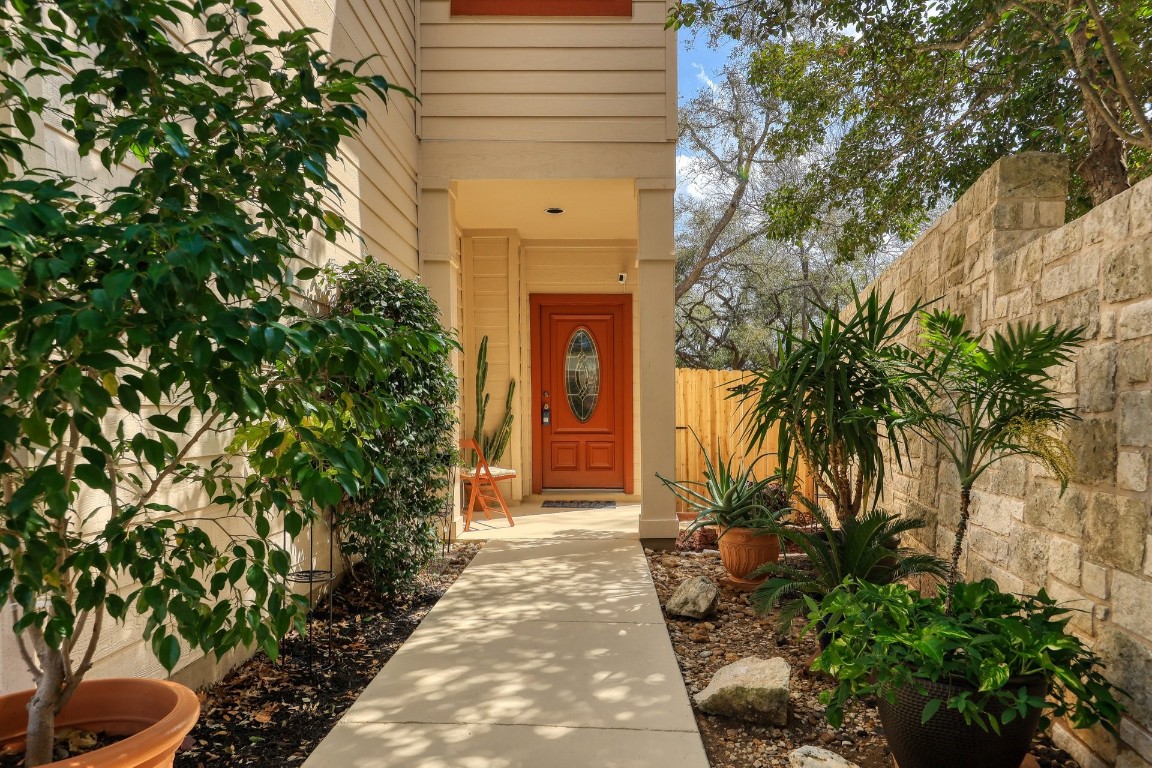 1303 Cuernavaca Drive North, Unit B Austin, TX 78733 - Photo 1 of 40 a front view of a house with a yard