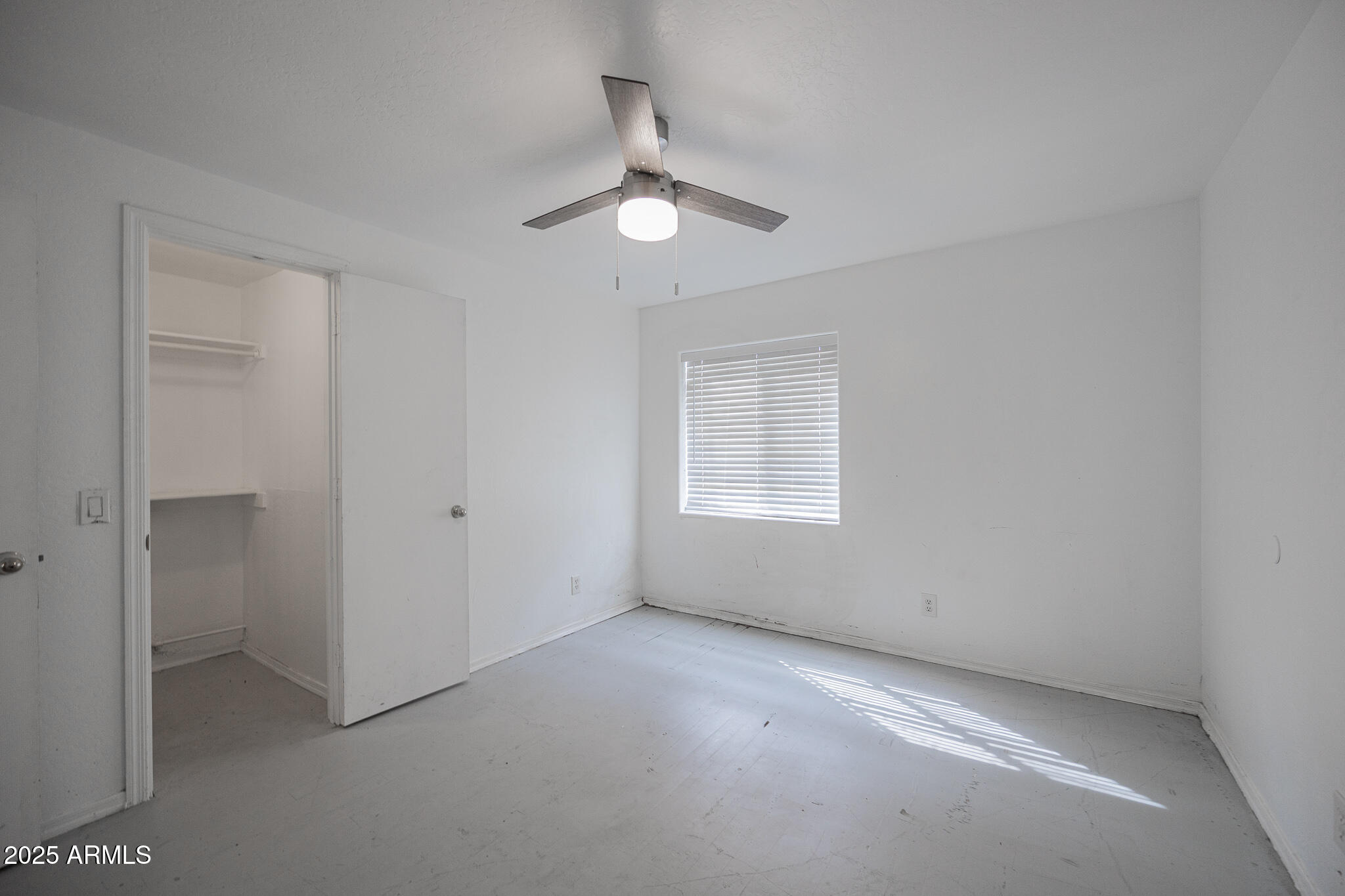 212 North 21st Avenue, Unit 4 Phoenix, AZ 85009 - Photo 15 of 15 an empty room with a empty space and a ceiling fan