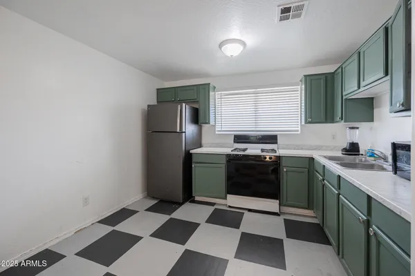 a kitchen with a refrigerator a sink and a stove