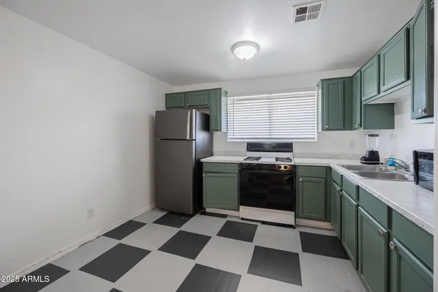 a kitchen with a refrigerator a sink and a stove