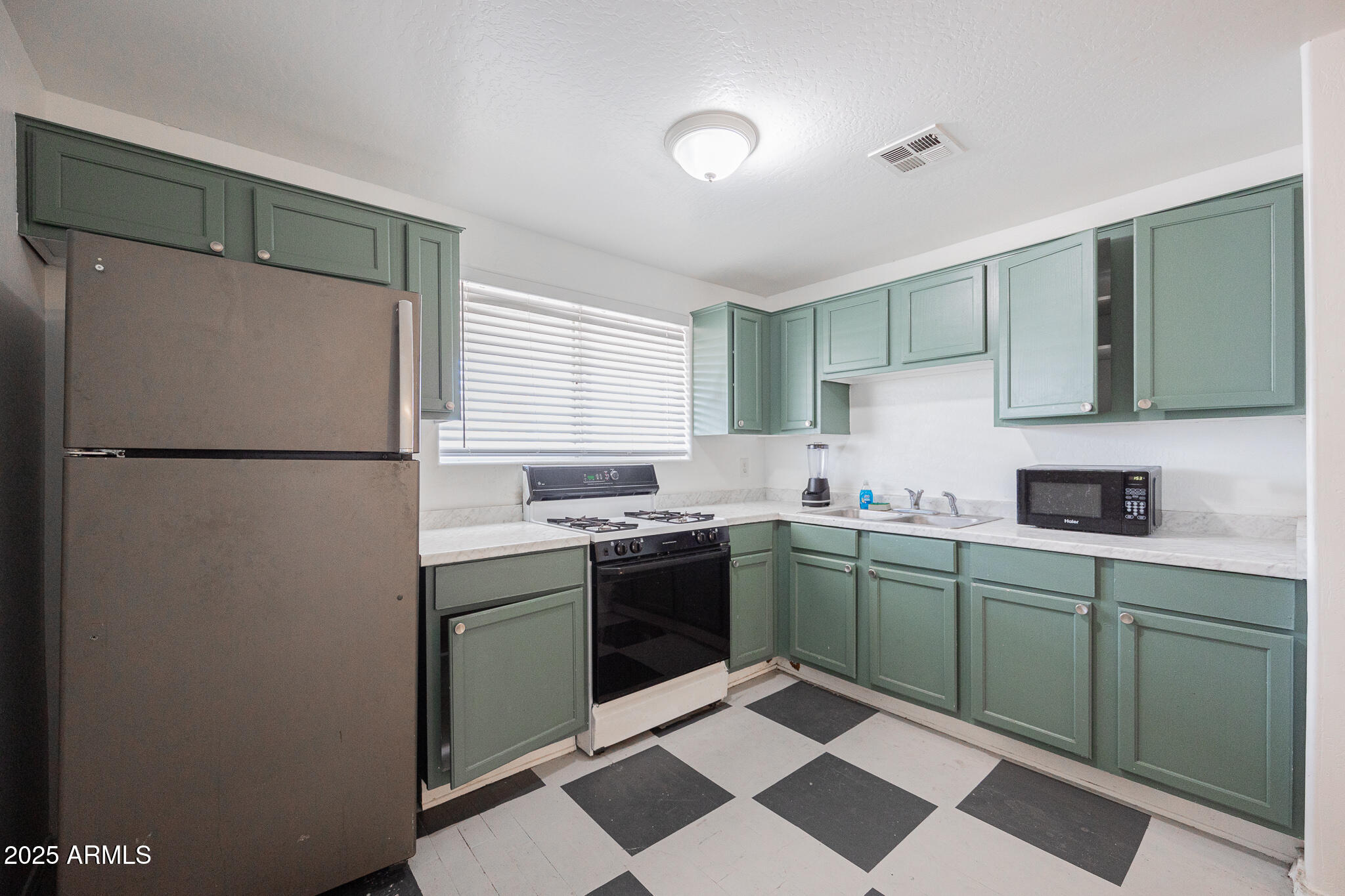 212 North 21st Avenue, Unit 4 Phoenix, AZ 85009 - Photo 6 of 15 a kitchen with a sink a refrigerator and cabinets