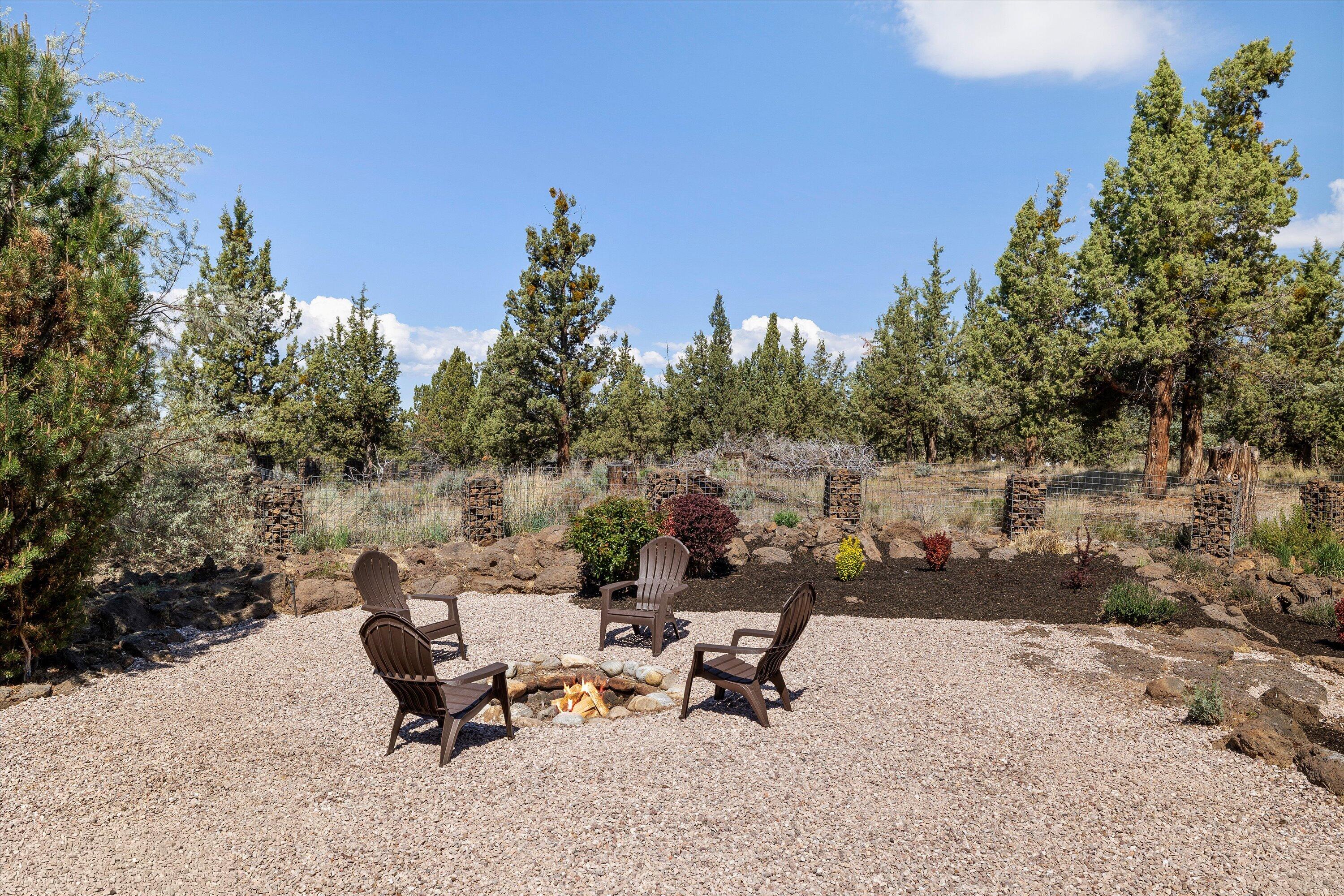 64155 Hunnell Road Bend, OR 97703 - Photo 44 of 96 Enjoy the warmth of a fire at night under the Central Oregon night sky.