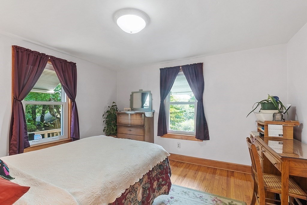 322 Patriots Road Templeton, MA 01468 - Photo 17 of 42 a bedroom with a bed window and wooden floor