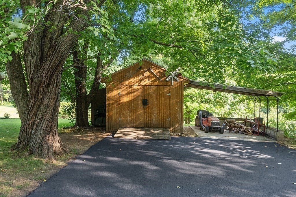 322 Patriots Road Templeton, MA 01468 - Photo 24 of 42 a view of a road with large trees