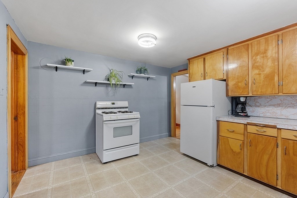 322 Patriots Road Templeton, MA 01468 - Photo 7 of 42 a kitchen with a refrigerator sink stove and cabinets
