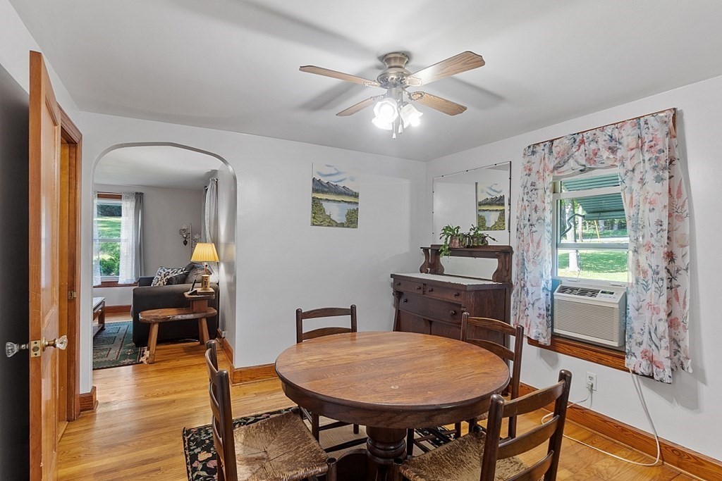 322 Patriots Road Templeton, MA 01468 - Photo 9 of 42 a dining room with wooden floor a chandelier a wooden table and chairs