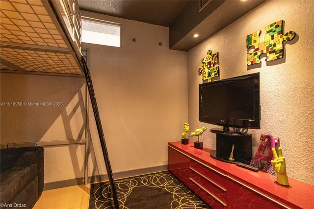 a room with furniture and flat screen tv