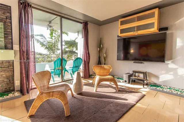 a living room with patio fireplace furniture and a flat screen tv