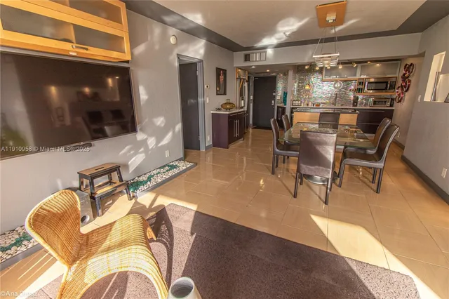 a room with stainless steel appliances kitchen island granite countertop furniture and a kitchen view