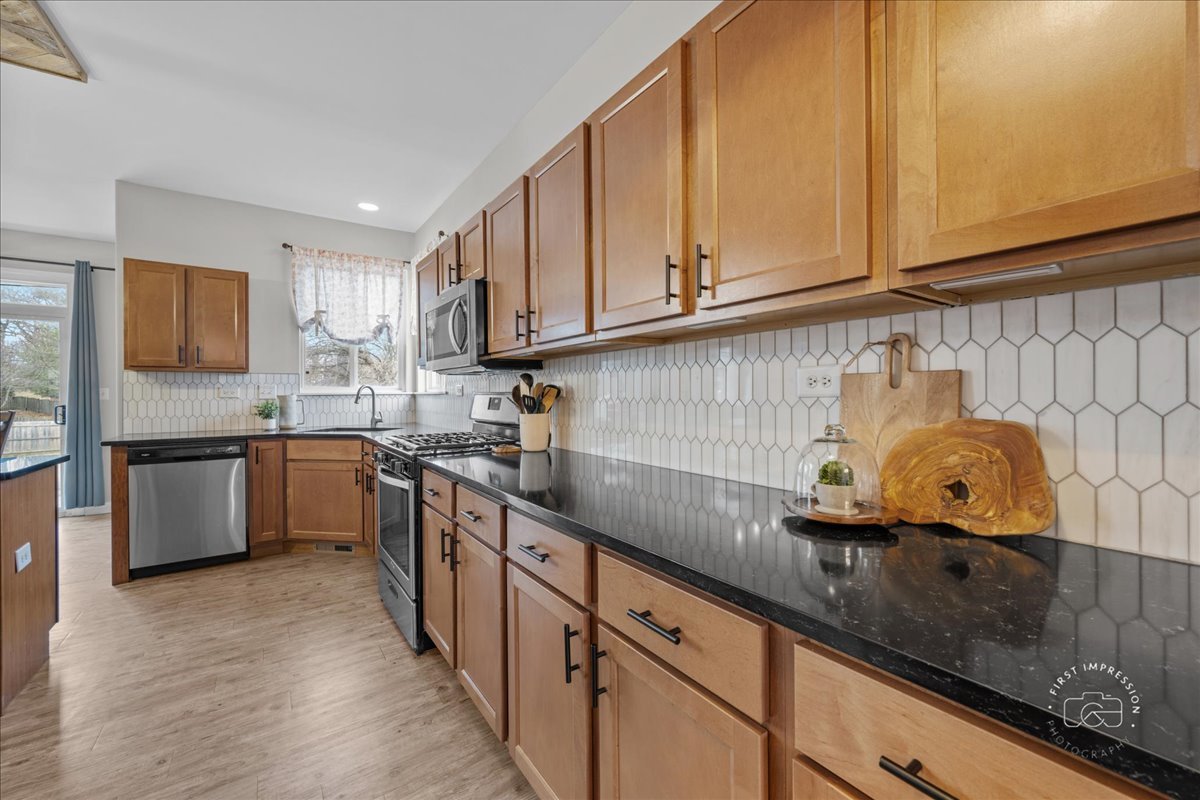 2924 Bauer Road North Aurora, IL 60542 - Photo 14 of 33 a kitchen with granite countertop a sink a stove and cabinets