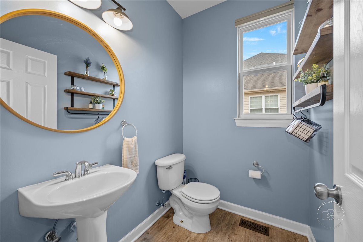 2924 Bauer Road North Aurora, IL 60542 - Photo 16 of 33 a bathroom with a sink a mirror and a toilet