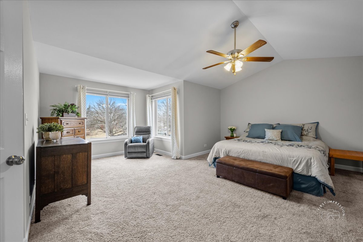 2924 Bauer Road North Aurora, IL 60542 - Photo 18 of 33 a spacious bedroom with a bed and a chandelier