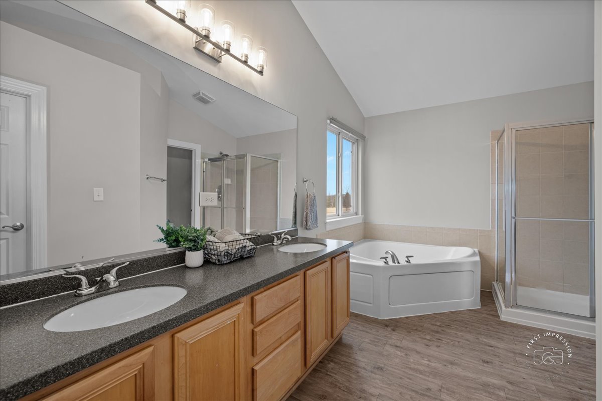 2924 Bauer Road North Aurora, IL 60542 - Photo 20 of 33 a bathroom with a granite countertop double vanity sink and mirror with bathtub