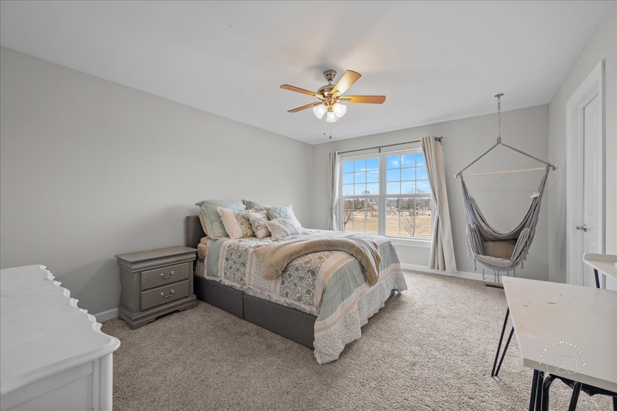 2924 Bauer Road North Aurora, IL 60542 - Photo 23 of 33 a spacious bedroom with a bed a window and a chandelier