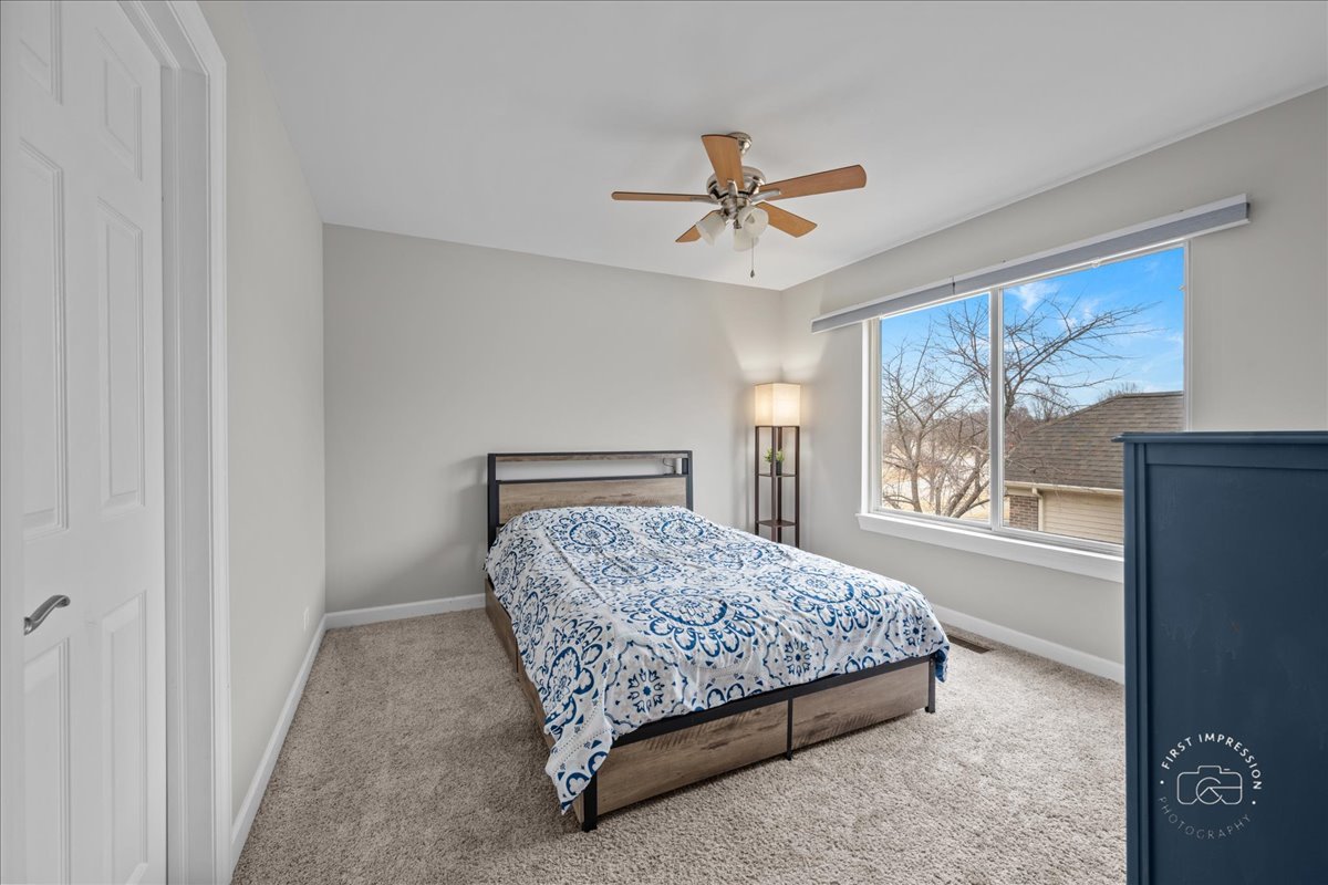 2924 Bauer Road North Aurora, IL 60542 - Photo 25 of 33 a bedroom with a bed lamp and a large window