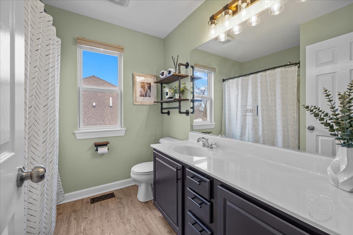 2924 Bauer Road North Aurora, IL 60542 - Photo 26 of 33 a bathroom with a sink a toilet and mirror