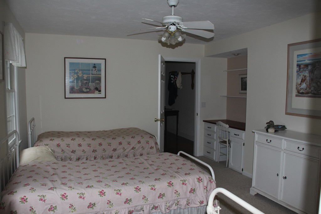 103 Wapping Road Kingston, MA 02364 - Photo 13 of 30 a bedroom with a bed and a chandelier