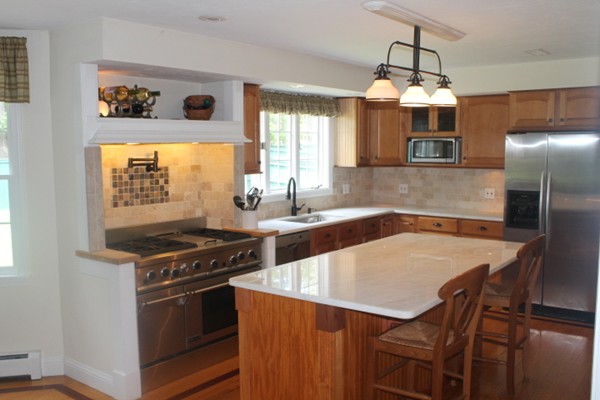 103 Wapping Road Kingston, MA 02364 - Photo 3 of 30 a kitchen with a stove a sink and a refrigerator