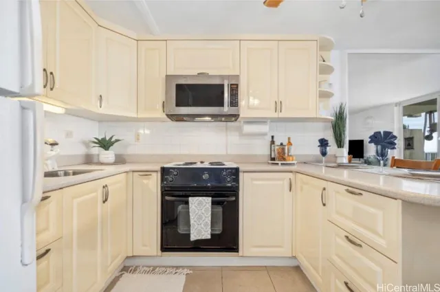 a kitchen with cabinets stainless steel appliances and sink