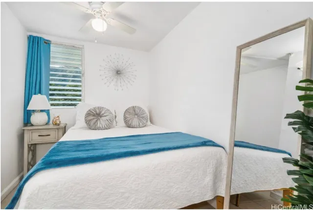 a bedroom with a large bed and chandelier