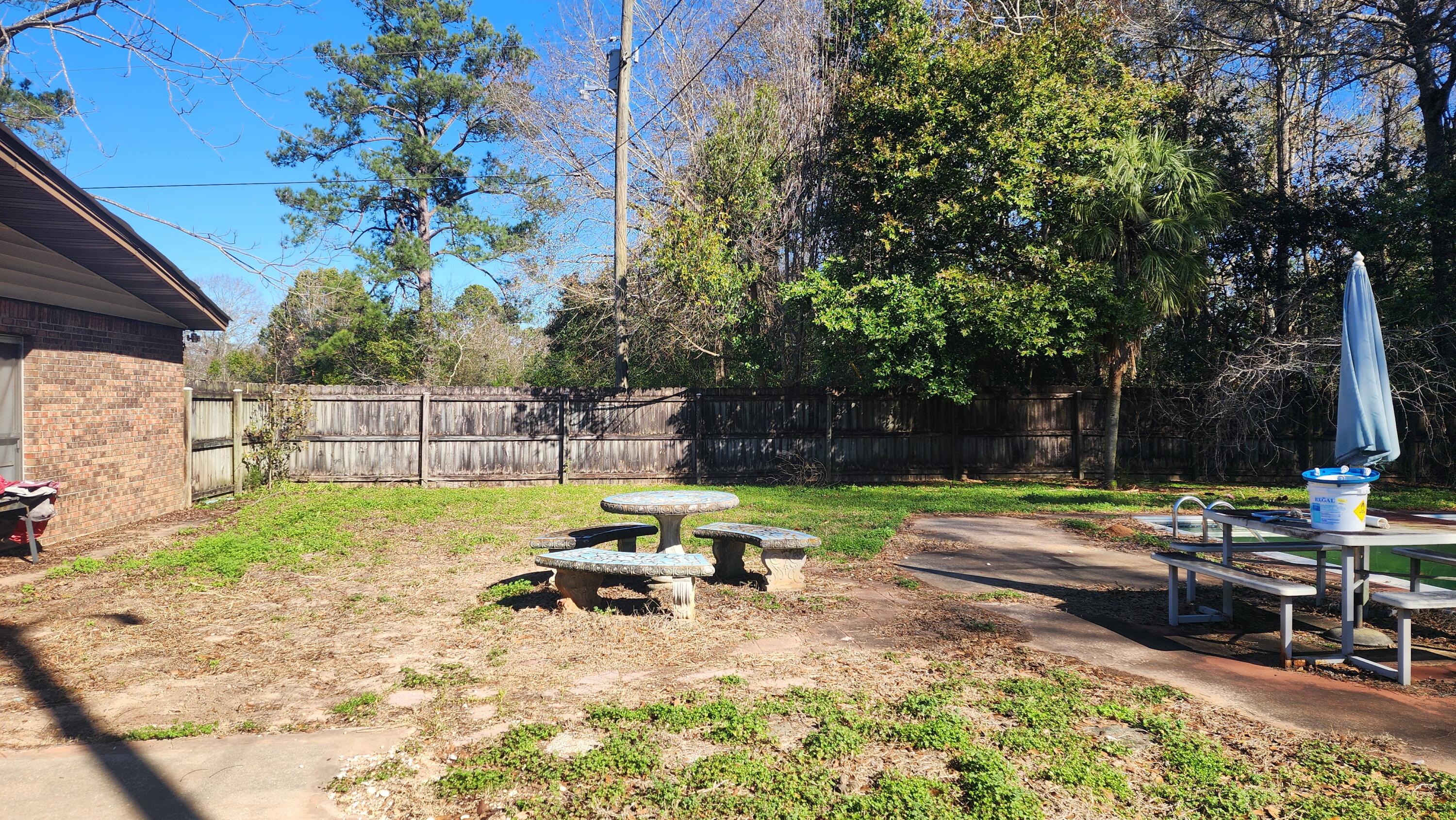 6127 Barnes Road Crestview, FL 32536 - Photo 3 of 16 a view of backyard with table and chairs