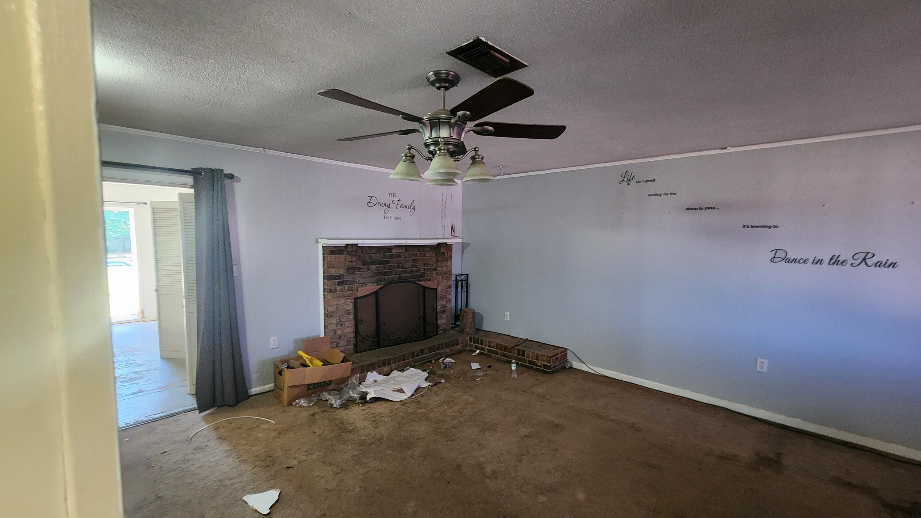 6127 Barnes Road Crestview, FL 32536 - Photo 5 of 16 a view of empty room with fireplace and fan