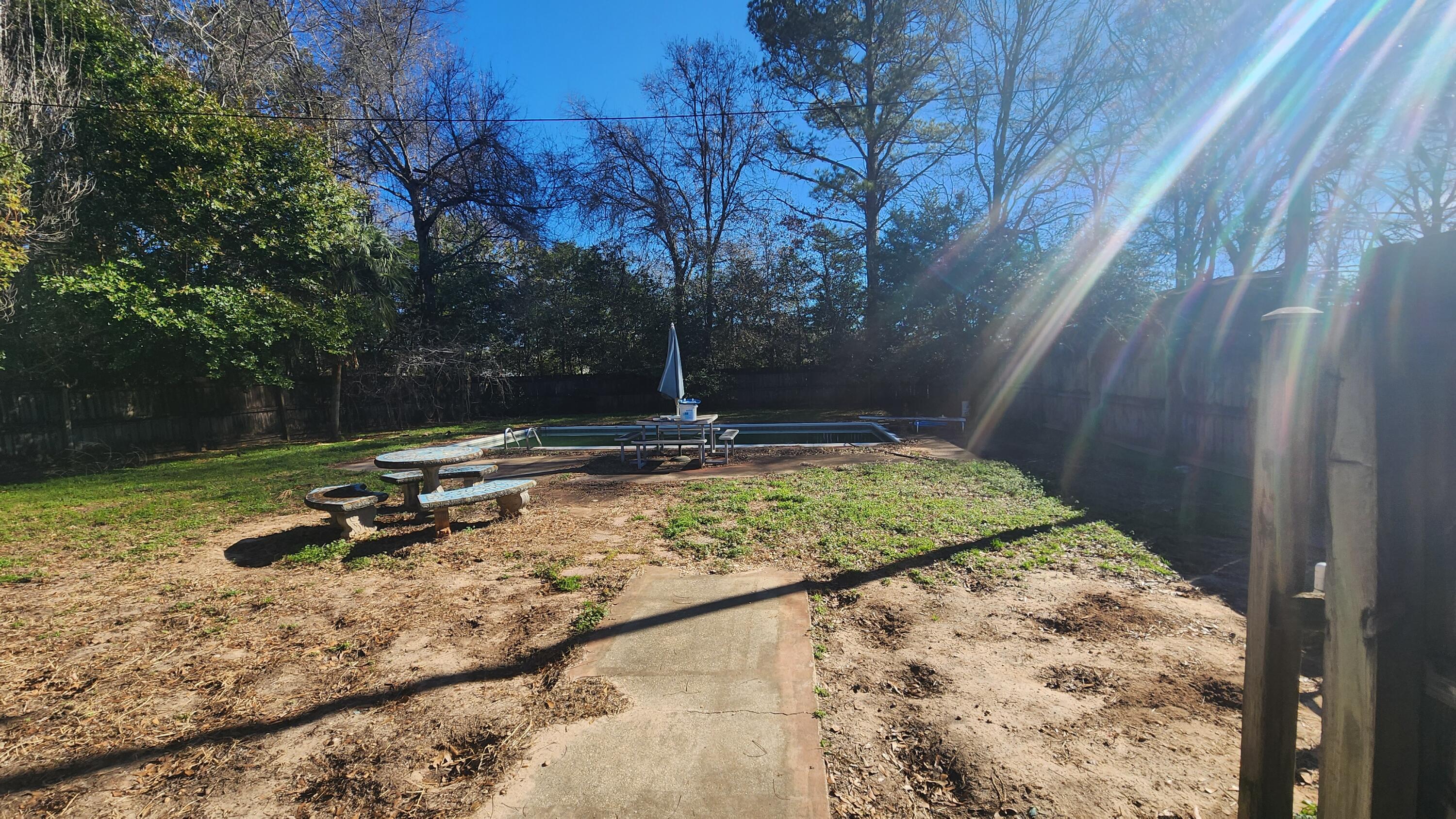 6127 Barnes Road Crestview, FL 32536 - Photo 6 of 16 a view of a backyard with large trees