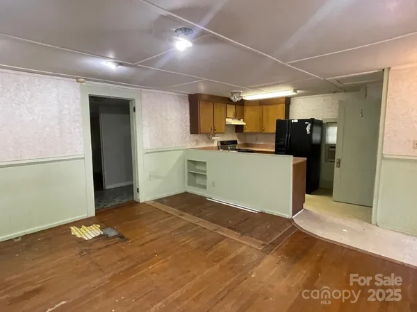 a kitchen with a refrigerator and a stove top oven