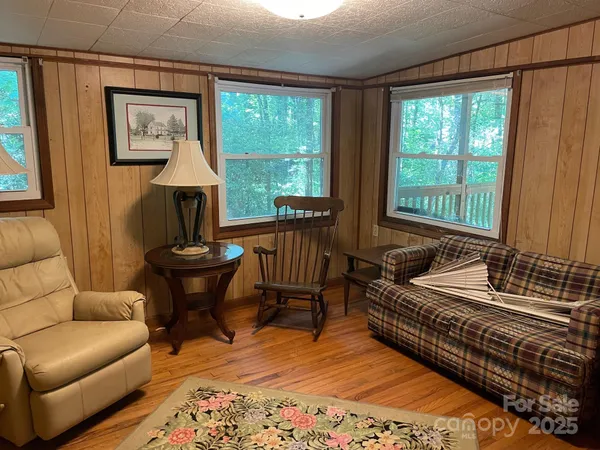 a bedroom with furniture and a large window