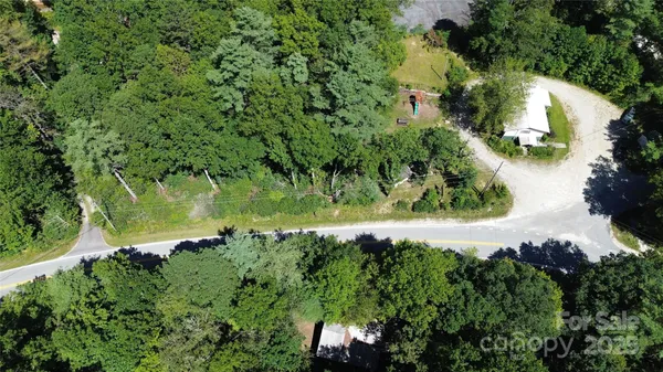 an aerial view of a house with a yard and outdoor seating