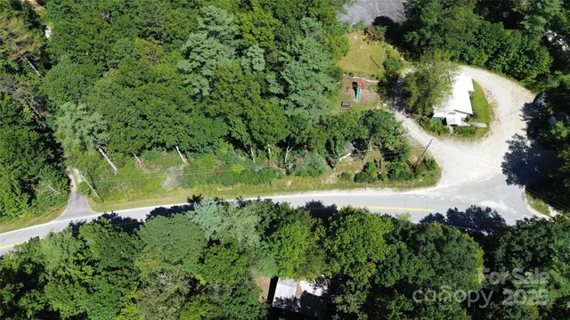 an aerial view of a house with a yard and outdoor seating