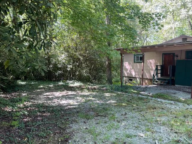 a view of a barn house in the middle of a yard