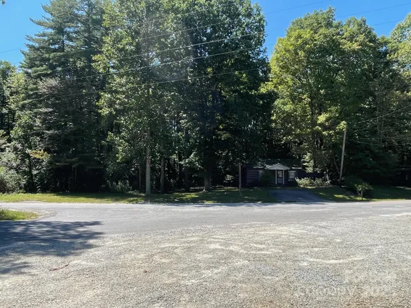a backyard of a house with lots of trees