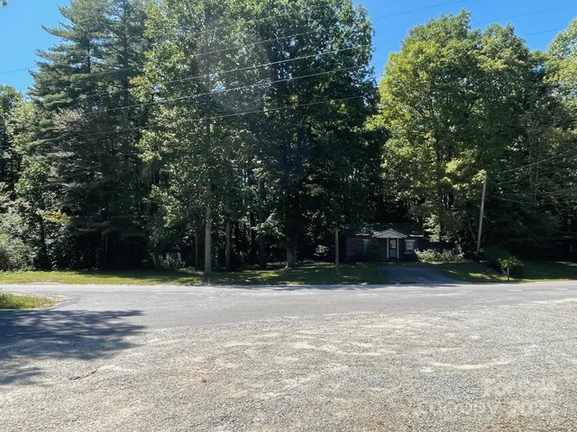 a backyard of a house with lots of trees