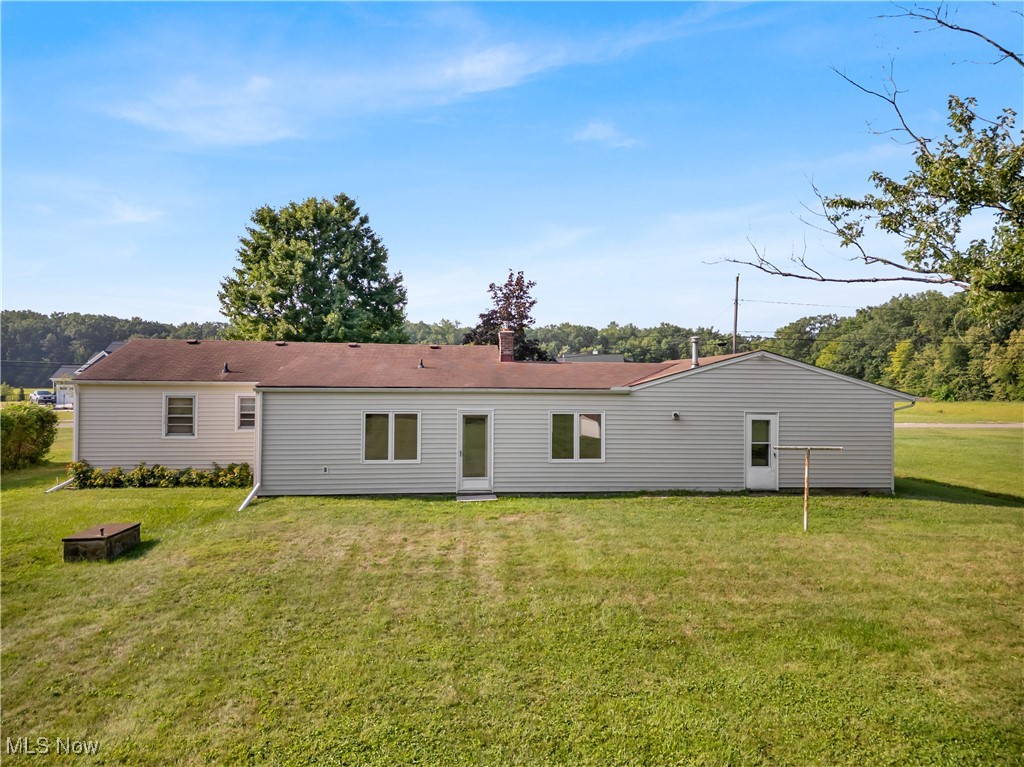 38450 Otten Road North Ridgeville, OH 44039 - Photo 8 of 45 Rear view of property with a yard and a chimney