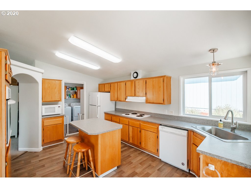 34148 Southeast Jarl Road Boring, OR 97009 - Photo 24 of 32 a kitchen with stainless steel appliances granite countertop a sink and cabinets
