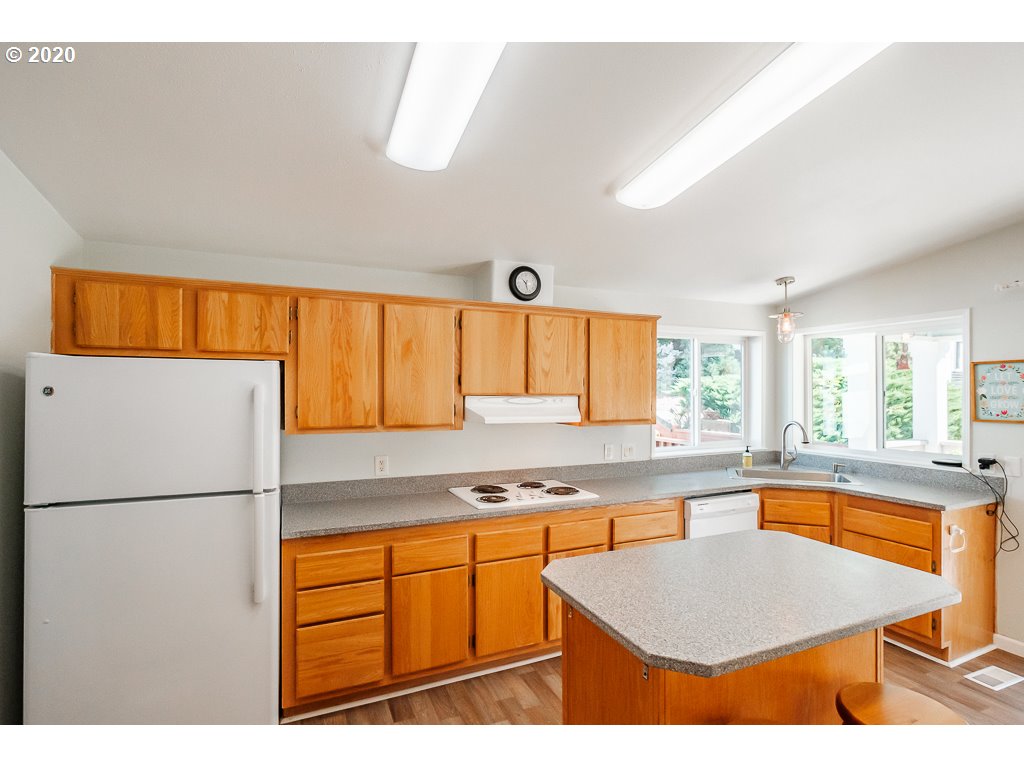 34148 Southeast Jarl Road Boring, OR 97009 - Photo 27 of 32 a kitchen with stainless steel appliances granite countertop a refrigerator sink and cabinets