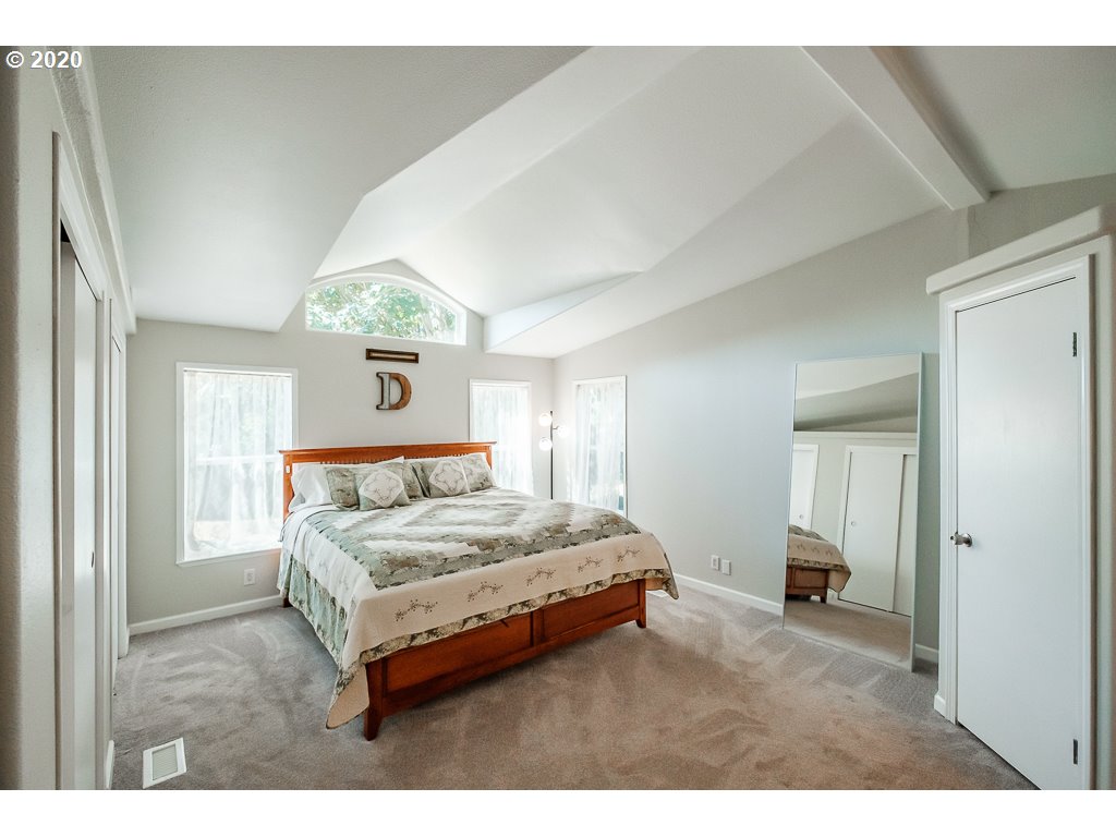 34148 Southeast Jarl Road Boring, OR 97009 - Photo 28 of 32 a bedroom with a bed and a large mirror